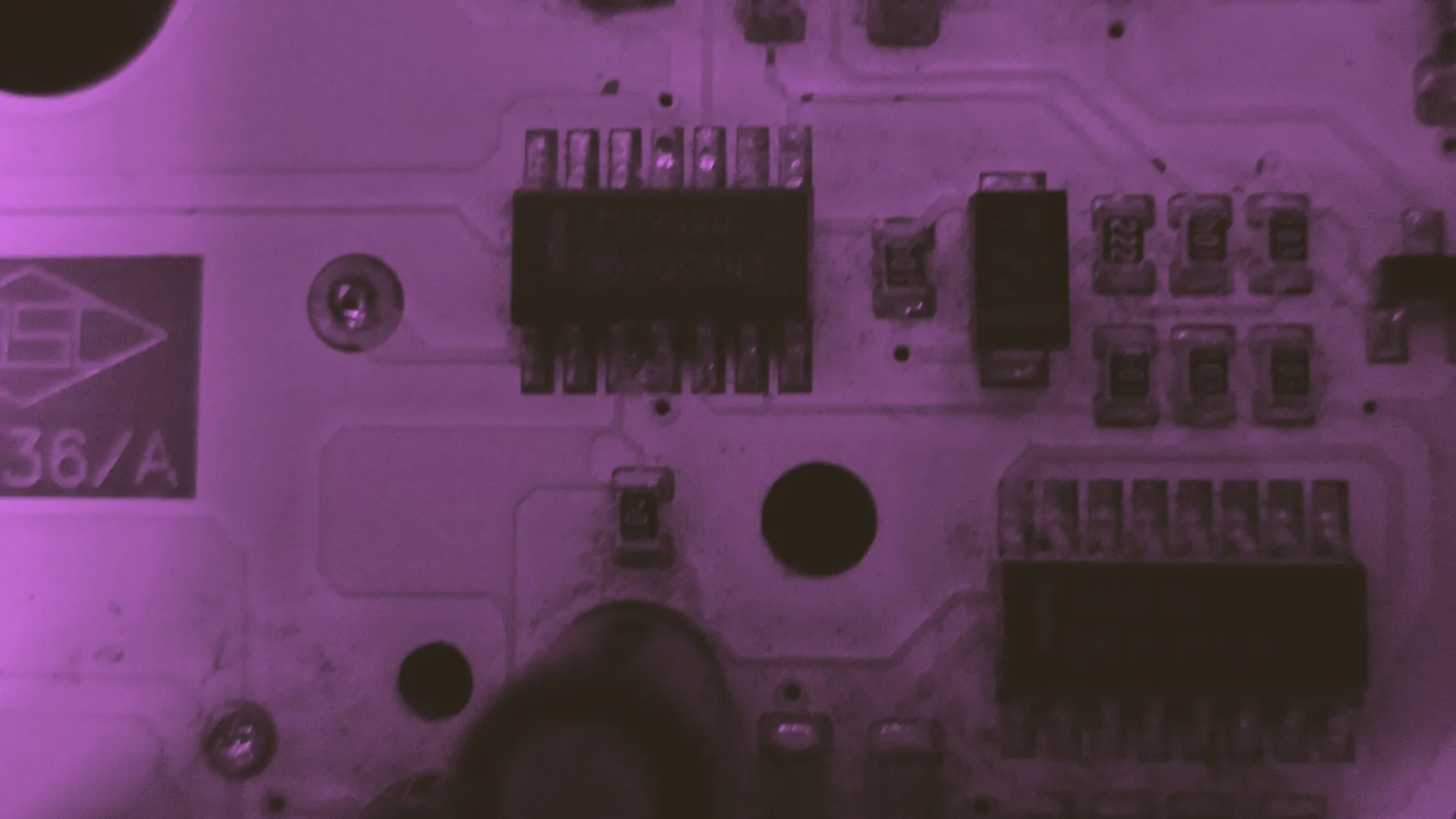 A printed circuit board photographed flat, its traces and mounted components in rows