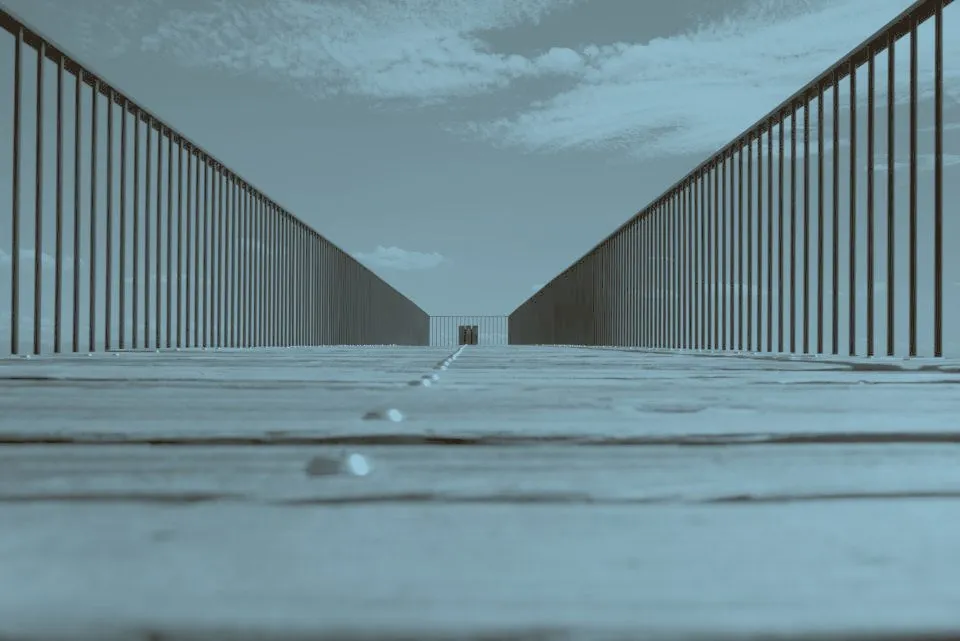 A steel structural frame photographed from below against open sky