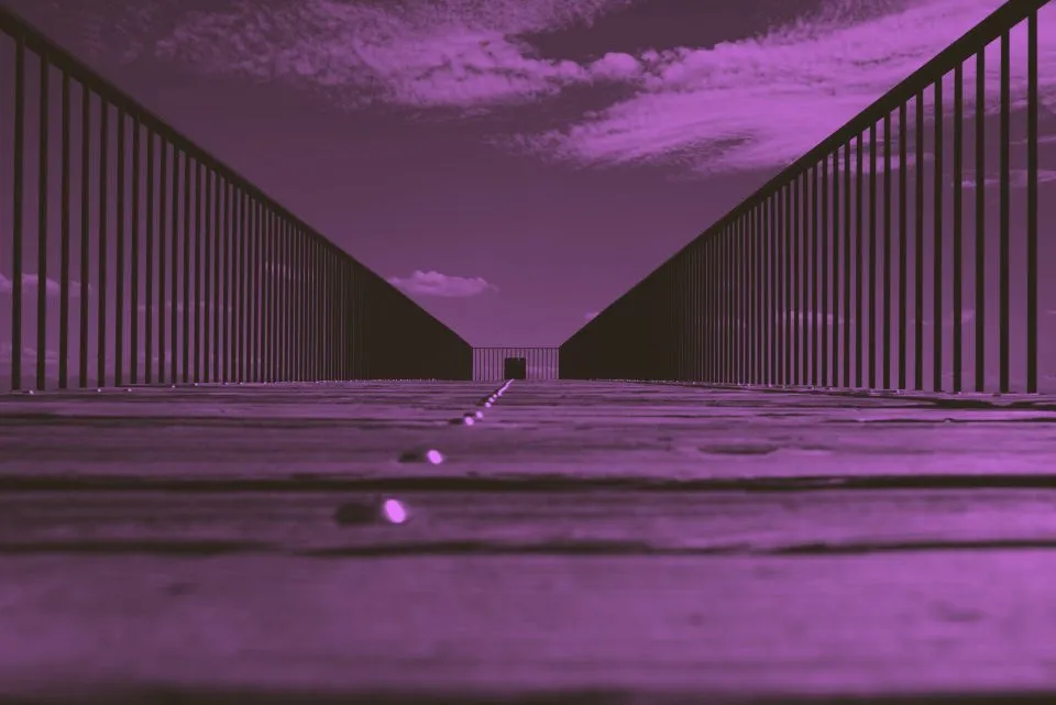 A steel structural frame photographed from below against open sky