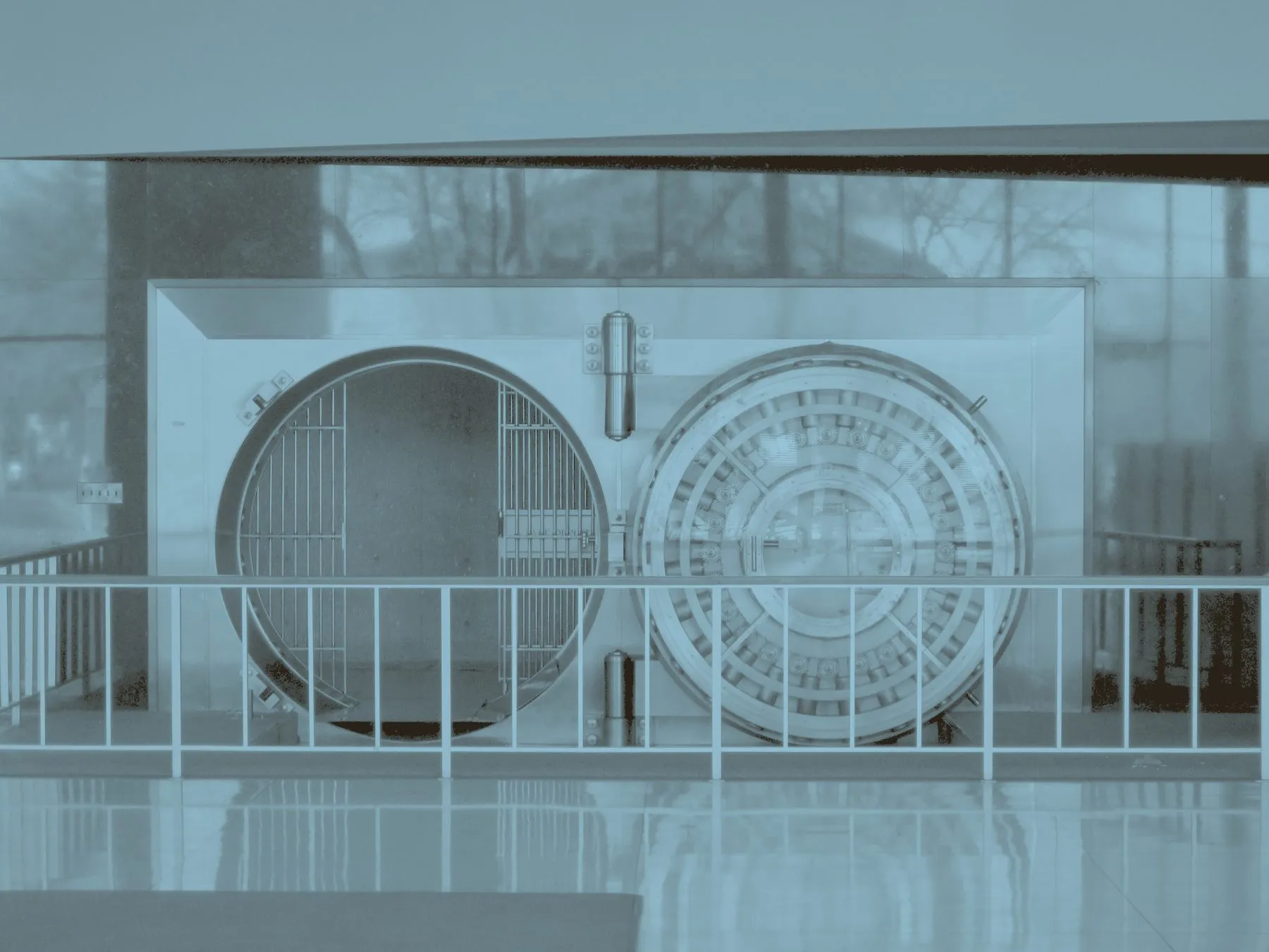 A bank vault standing open, its door thickness and locking mechanism visible